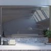 Wall mounted stainless steel framed mirror with a vanishing TV.